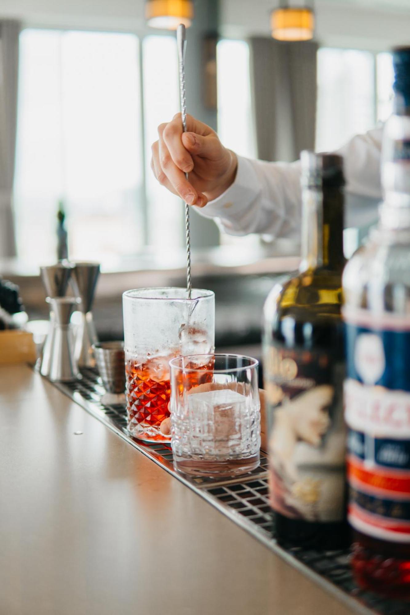 J44 Lifestyle Hotel Lido di Jesolo Luaran gambar A bartender stirring a cocktail